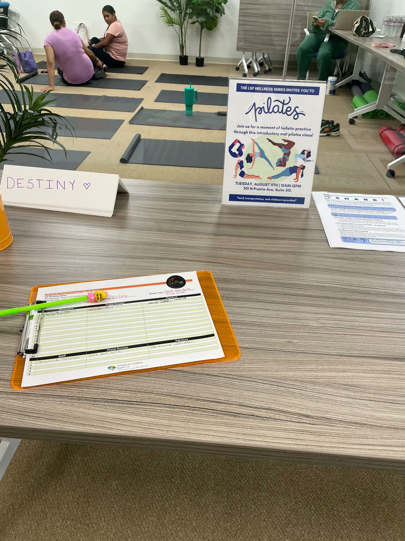 Sign-in sheet and pilates session flyer at the Life Skills Program